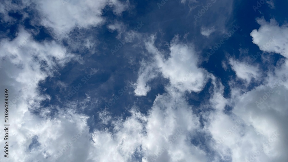 Obraz premium Deep Blue Sky with Dramatic Soft White Cloud Texture Background