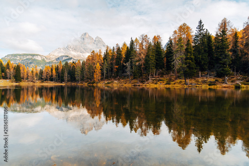 Scenic Alpine Lake in Autumn, Vibrant Fall Forest and Distant Mountain Peak on the Horizon in Natural Light