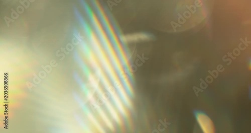 Slow motion of lens flare isolated on black background. Colored spectrum. Cinematic glowing light overlay with optical streaks and rays for VFX compositing and transitions.
