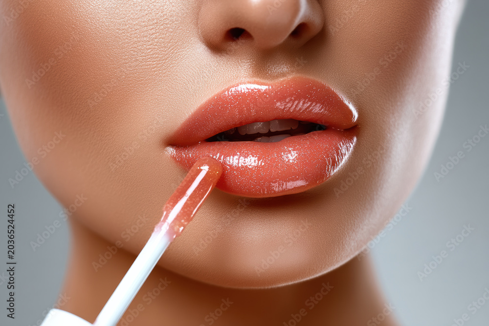 Naklejka premium “Glossy lips close up makeup beauty female smooth skin sensual cosmetic glamour shine applying lip gloss for radiant and attractive look.”