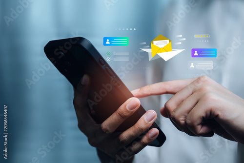 Communication concept. Hand using smartphone with email envelope and message cards, customer service, online communication, email marketing, digital feedback, mobile app