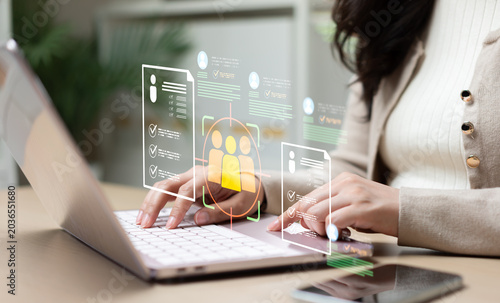 Konstfotografi Businesswoman analyzing candidate recruitment data on laptop with virtual HR interface, representing employee screening, talent acquisition, digital hiring, and workforce management