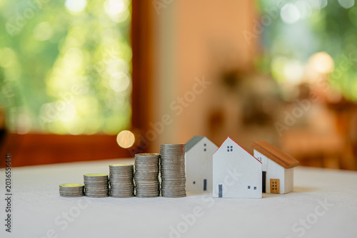 Concepts of saving and investing. Investing in houses and land. Growth of the real estate business. House and land taxes. Banks and home loans.