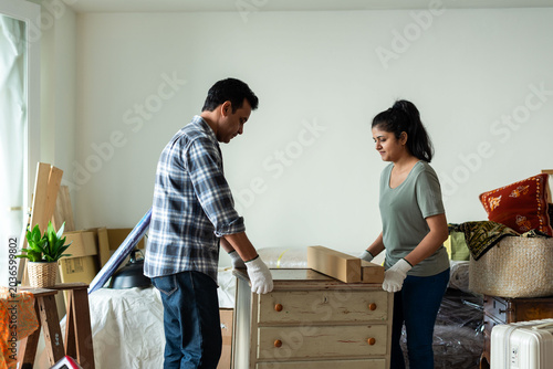 Photography Couple assembling furniture together photo
