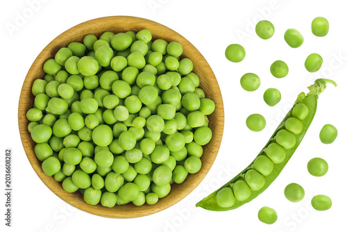 Fresh green peas in wooden bowl isolated on white background. Top view. Flat lay