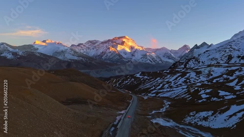 Sunrise over Snow Covered Himalayan Mountains and Winding Road in Himalayas