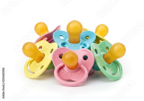 Pile of Colorful Baby Pacifiers Isolated on White Background - Set of Multi-Colored Silicone Soothers for Infants