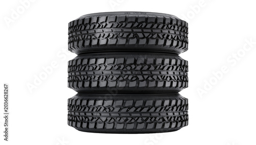 Photos Stack of three black rubber off-road tires with deep treads