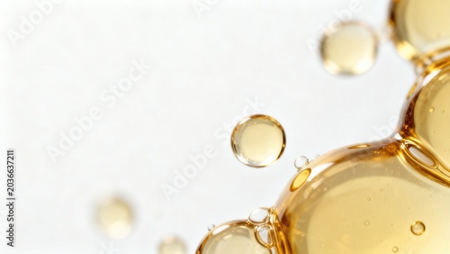 Golden liquid bubbles on white background