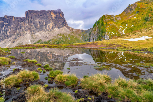 Mirror reflections of Ra Gusela pond in the Dolimte Alps, Italy
