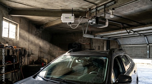 Smart Garage Door Controller Ceiling-Mounted Near Garage Door Opener with Car Windshield Reflection