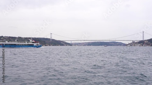 The Istanbul Bosphorus Bridge, ships and cars crossing the Bosphorus Strait