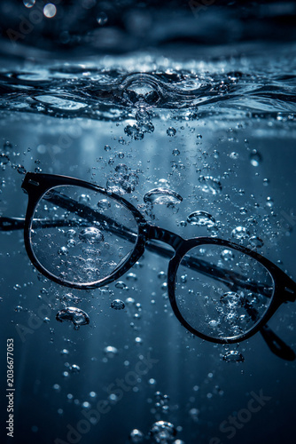Eyeglasses Floating Underwater in Dramatic Blue Light