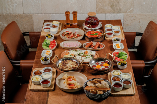 Traditional Azerbaijani breakfast table for four person. Traditional carpet on background