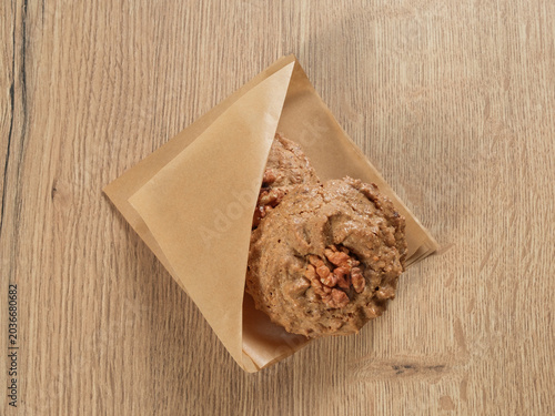 Cookies in paper close up top view isolated on wooden table