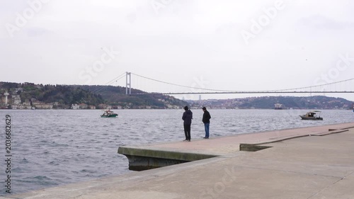 The Istanbul Bosphorus Bridge, ships and cars crossing the Bosphorus Strait