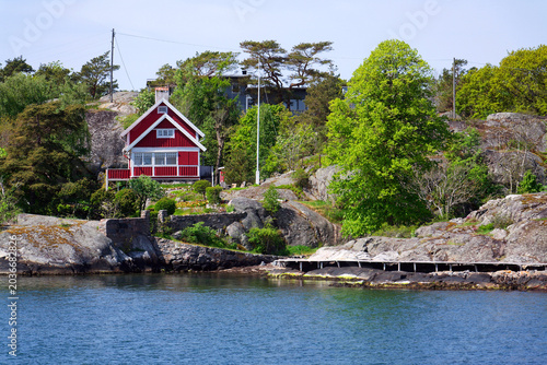 Beautiful holiday cottages on shore of Gothenburg archipelago islands, Gothenburg Minucipality, Vastra Gotaland County, Sweden, sunny day