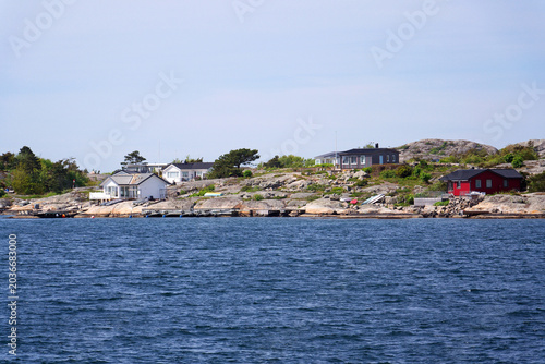 Beautiful holiday cottages on shore of Gothenburg archipelago islands, Gothenburg Minucipality, Vastra Gotaland County, Sweden, sunny day