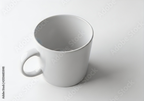 A simple white ceramic mug with a handle, set against a plain background.