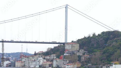 The Istanbul Bosphorus Bridge, ships and cars crossing the Bosphorus Strait