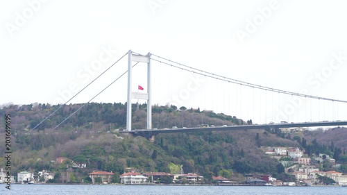 The Istanbul Bosphorus Bridge, ships and cars crossing the Bosphorus Strait