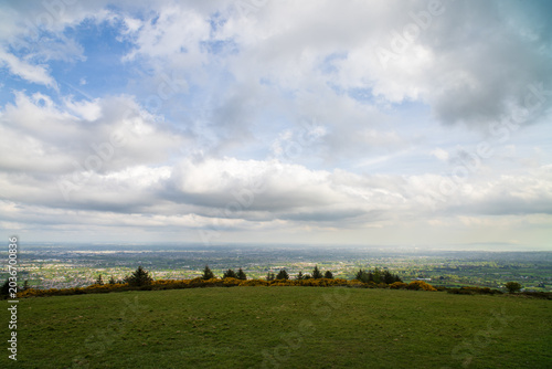 Billede på lærred Panoramic hilltop view over Irish cityscape with gorse and conifers