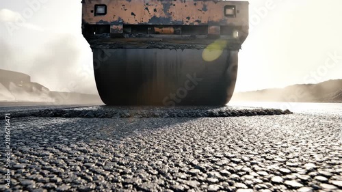 Road roller heavy machinery compacting hot asphalt on construction site. Compaction process of fresh road surface. Industrial paving equipment for infrastructure.