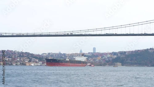 The Istanbul Bosphorus Bridge, ships and cars crossing the Bosphorus Strait