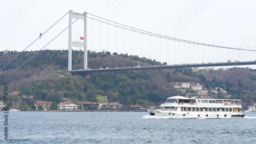 The Istanbul Bosphorus Bridge, ships and cars crossing the Bosphorus Strait