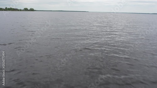 A high-quality 4K 60fps cinematic shot capturing the serene beauty of a boat trip on a calm lake. The footage features natural, authentic ambient audio, including the steady hum of the boat motor
