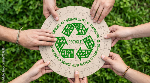People holding circular jigsaw puzzle with recycle symbol. Teamwork for environmental sustainability and conservation. Group cooperation to promote waste reduction and green living lifestyle.