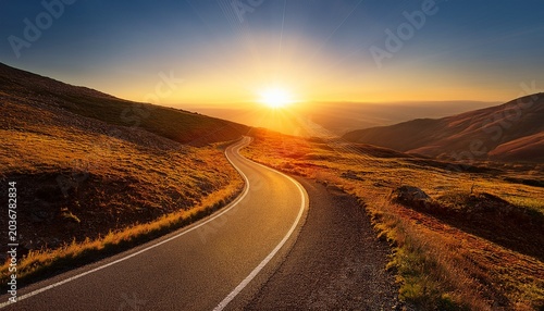 A Winding Road Leads Towards A Bright Stylized Sun Rising On The Horizon