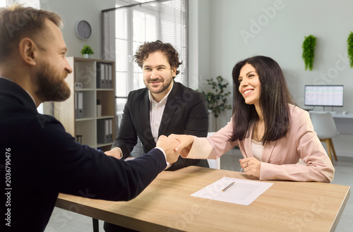фотографія Interview recruiters greet candidate with hiring handshake
