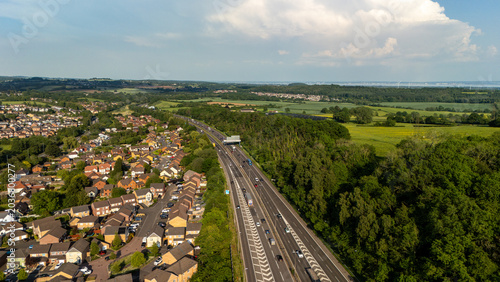 Aerial view of motorway by suburban homes and countryside