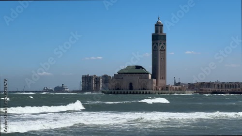 Hassan II Mosque rising above Atlantic Ocean waves in Casablanca Morocco