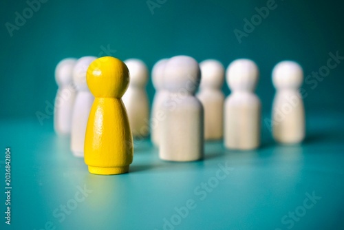 Fotografie Close Up Profile of Yellow Figure Leading White Team