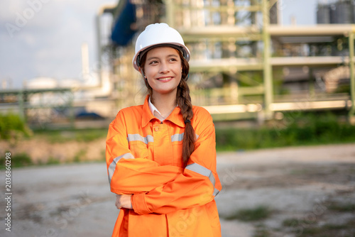 Female engineer smiling at industrial plant building success