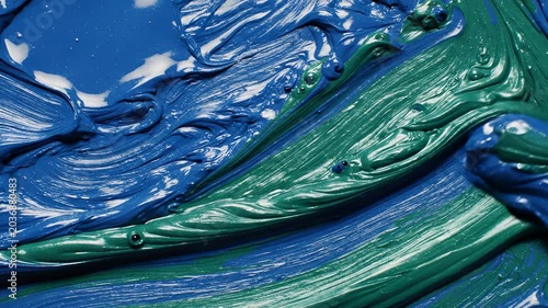 Closeup of thick blue and green oil paint textures.