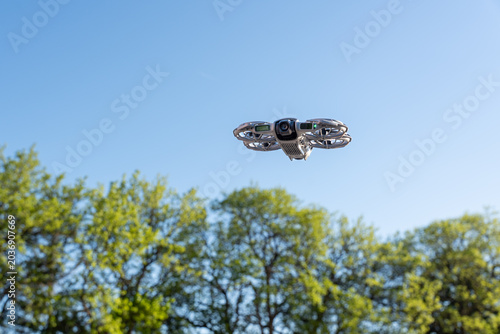 Quadro su tela A drone with protective circular guards around its propellers hovering against a