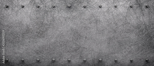Fotografie Dark grunge scratched metal texture background with iron rivets.