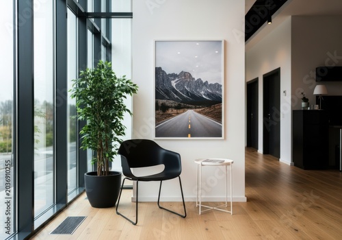 Modern interior with a black chair and mountain landscape picture