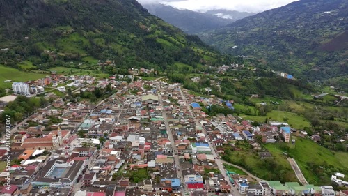 Aerial drone forward tracking over Choachi town in green mountain valley