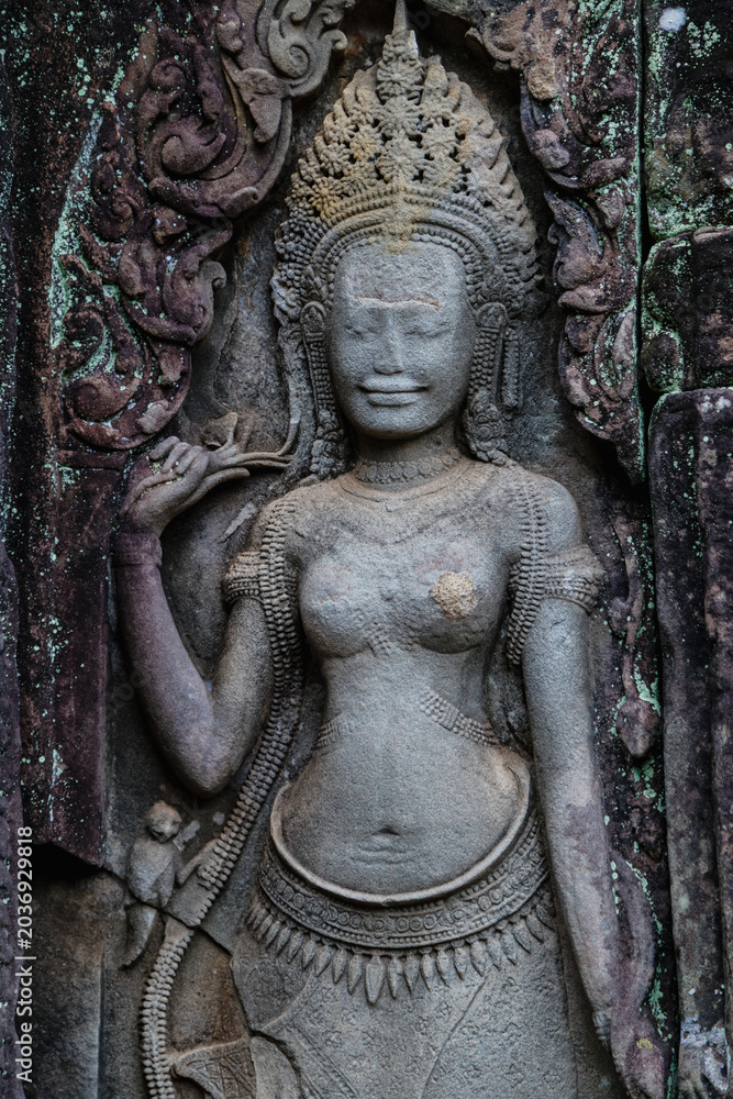 Fototapeta premium Apsara dancer carved into stone at Angkor Wat, Bayon Temple, Siem Reap, Cambodia. These celestial dancers are a common motif in Khmer art and architecture.