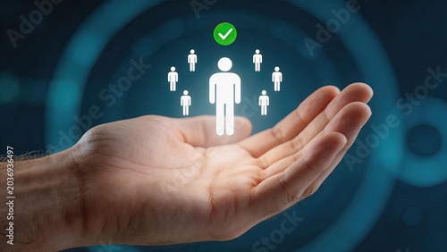 Human hand holding holographic icons of people and checkmark symbolizing human resources, recruitment, team selection, employee management and hiring process in digital technology