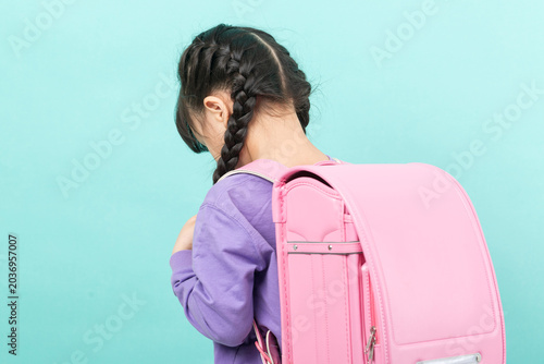 Foto Sad and discouraged little girl looking down in shame or sorrow, childhood depression and loneliness concept