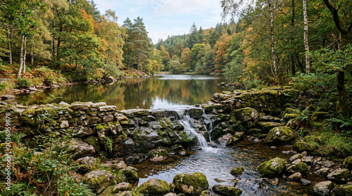 Peaceful water reservoir catchment located in a national park featuring a small rustic stone overflow