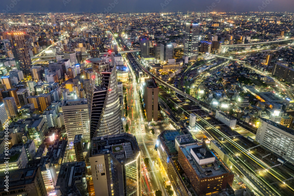 Fototapeta premium Nagoya central business district skyline on the evening, modern skyscrapers, roads and railways under twilight sky.