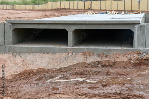 Concrete box culvert installed at a multifamily residential development site, representing stormwater infrastructure, drainage systems, and apartment construction support