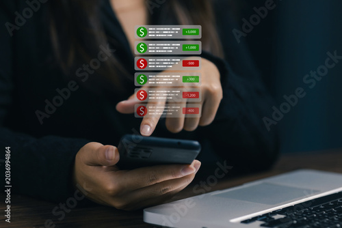 Photos Businesswoman using smartphone with digital financial transaction notifications, mobile banking alerts and online payment activity