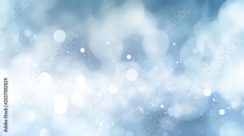 Abstract blue background with soft bokeh lights and sparkling particles
